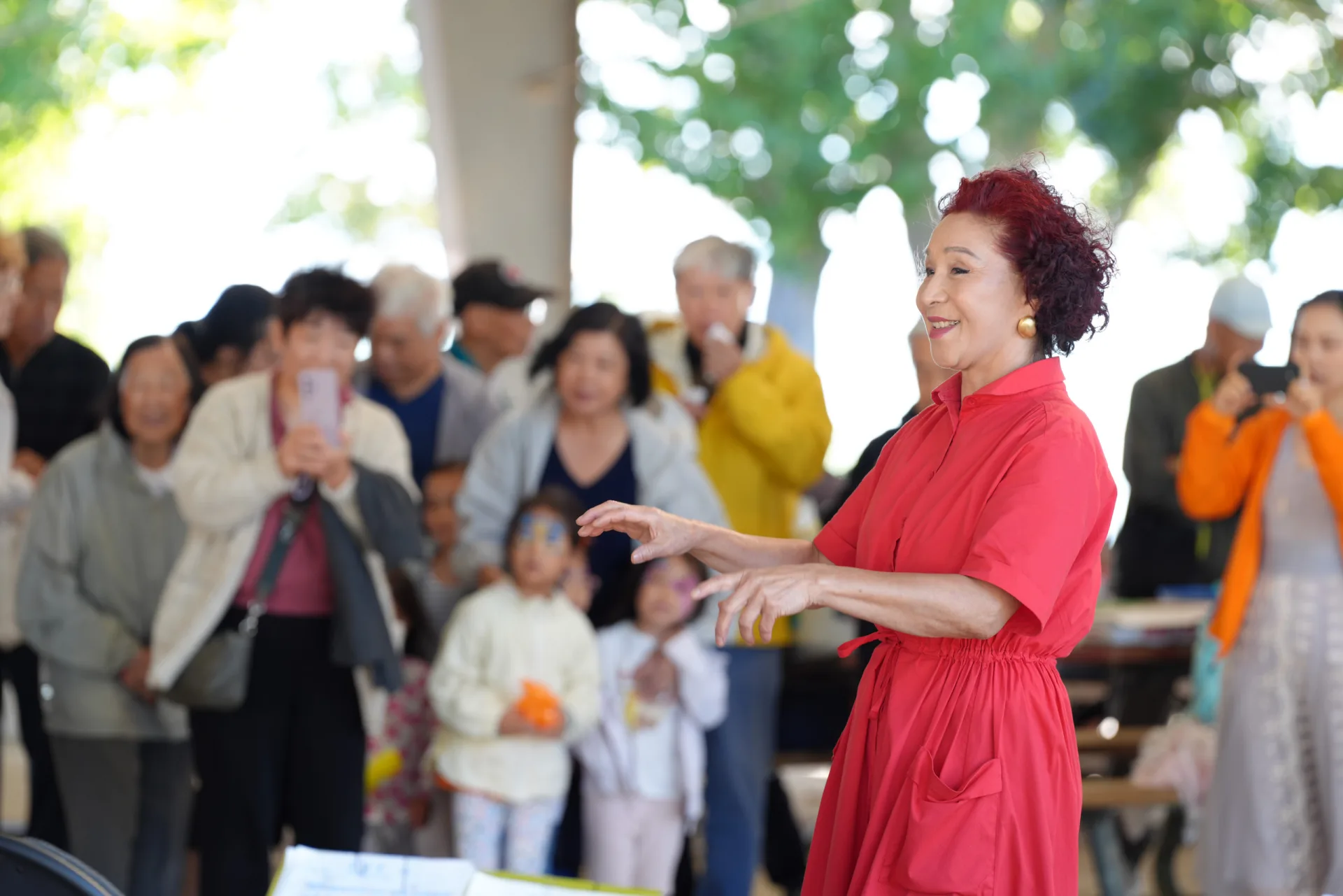 Community member leading a performance at an outdoor CCAKD gathering in Kingston